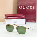 Gucci sunglasses with gold-tone frame and green tinted lenses