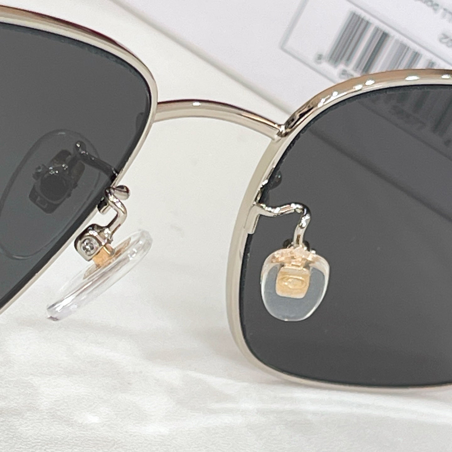 Gucci sunglasses close-up of gold bridge with dark lenses and rhinestone detail