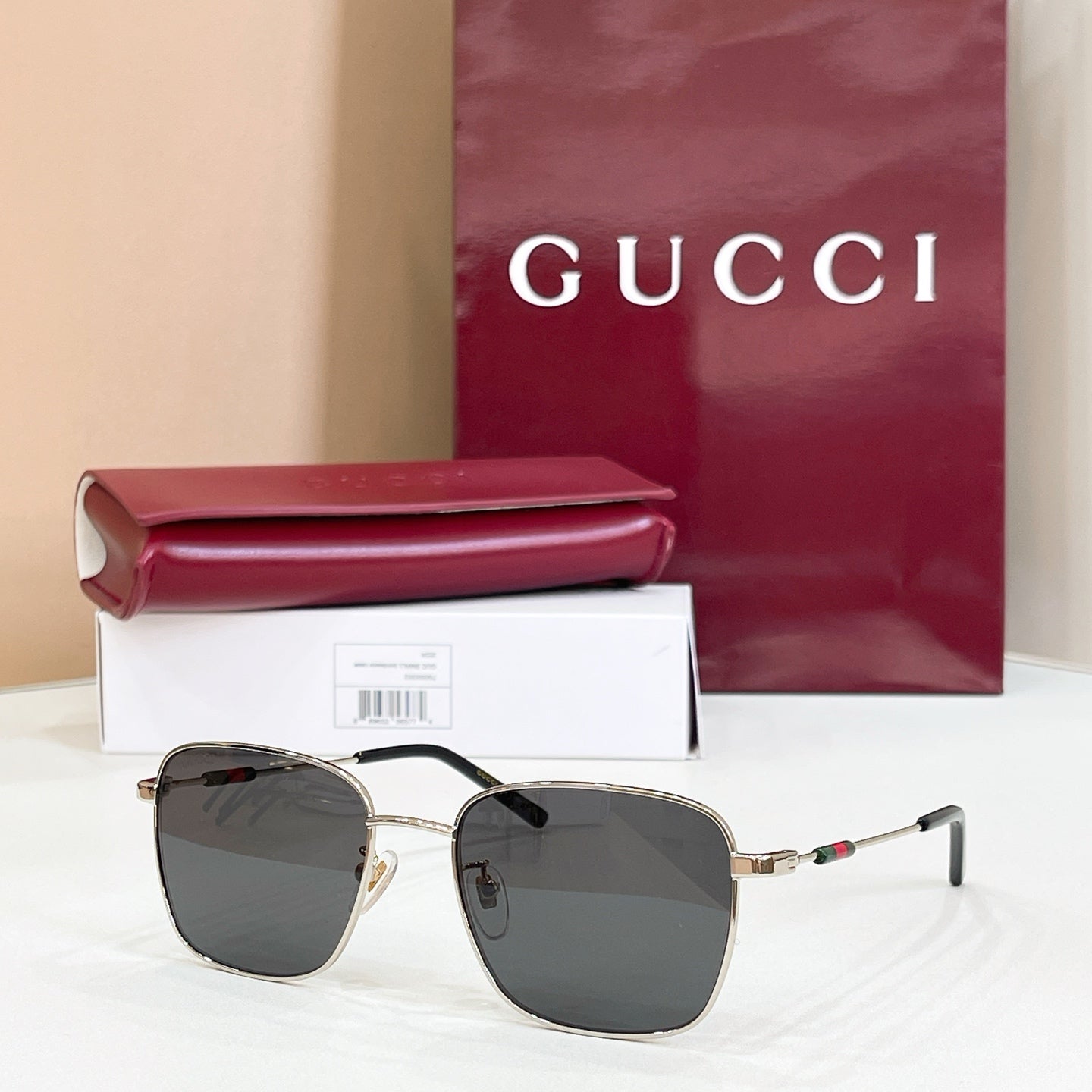 Gucci rectangular sunglasses with dark gray lenses and gold-tone metal frame
