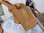 Louis Vuitton tan leather tag with gold stitching on light blue monogram bag