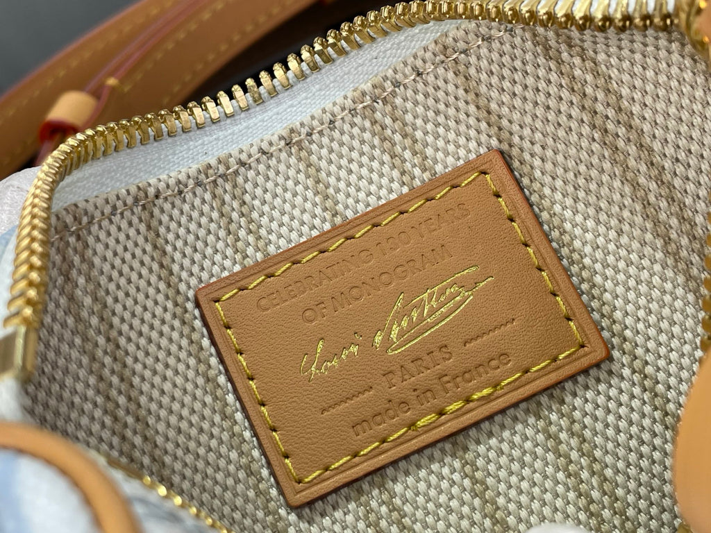 Louis Vuitton interior woven label with gold lettering on tan leather patch