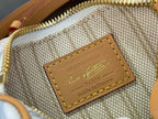 Louis Vuitton interior woven label with gold lettering on tan leather patch