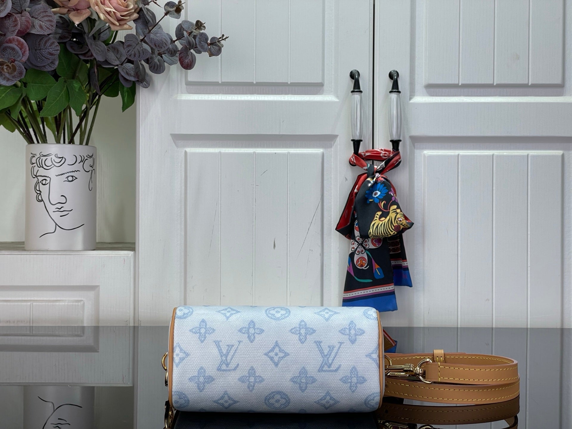 Louis Vuitton light blue monogram bag with tan crossbody strap and zip top