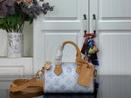 Louis Vuitton handbag in light blue with monogram pattern and tan leather handles