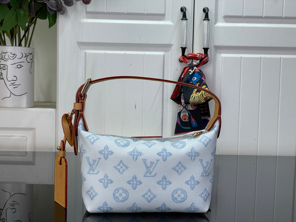 Light blue monogram canvas shoulder bag with tan side strap and top handle