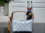 Light blue monogram canvas shoulder bag with tan side strap and top handle