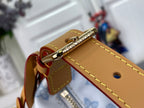 Gold hardware and tan leather strap on light blue monogram canvas bag