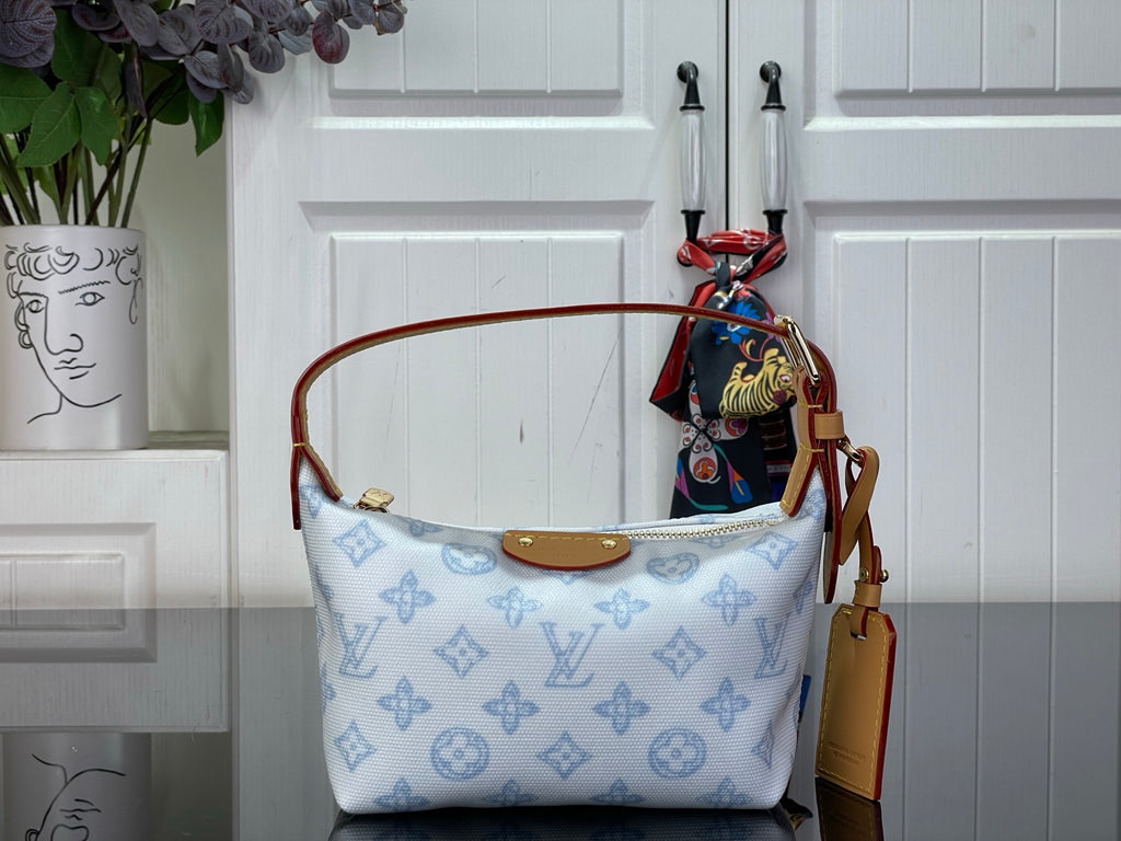 Light blue monogram canvas shoulder bag with tan leather trim and top handles
