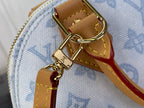 Blue monogram bag with tan strap and gold swivel clasp hardware detail.