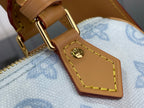 Leather bag handle strap with gold buckle hardware and yellow stitching, light blue lining