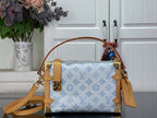 Blue monogram handbag with tan leather trim, gold hardware, and crossbody strap