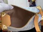 Blue monogram handbag interior view with tan lining and zipped top closure
