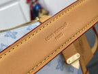 Tan leather bag strap edge with stamped 'LOUIS VUITTON PARIS' text and yellow stitching