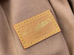 Leather Louis Vuitton bag label patch with green-stitched border and script logo