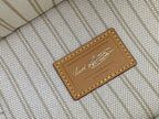 Louis Vuitton interior label on fabric lining with stitched tan leather frame