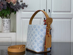 Louis Vuitton tote bag side view in light blue monogram canvas with tan leather strap details