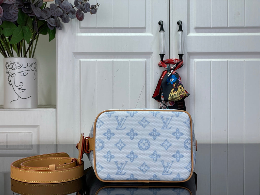 Louis Vuitton shoulder bag in light blue monogram canvas with tan flap and top handle