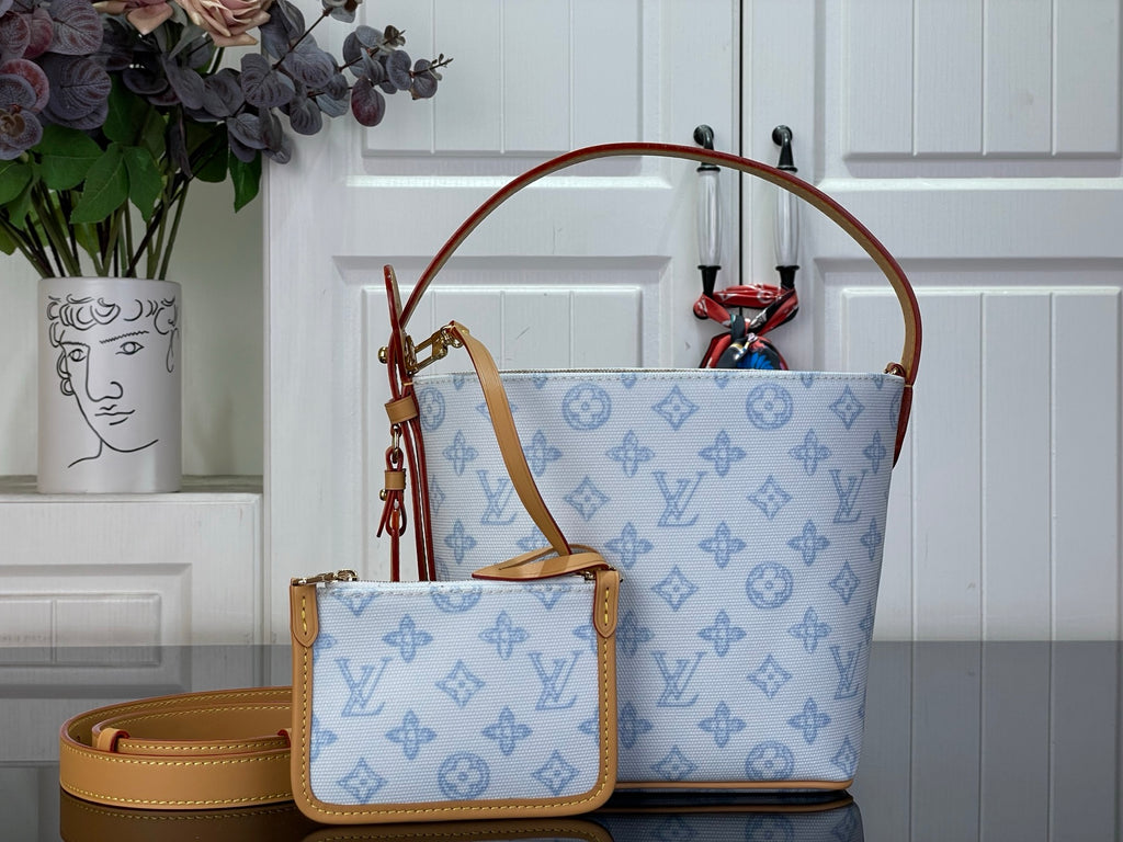 Louis Vuitton tote bag in light blue monogram canvas with tan leather trim and handles