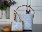 Louis Vuitton tote bag in light blue monogram canvas with tan leather trim and handles
