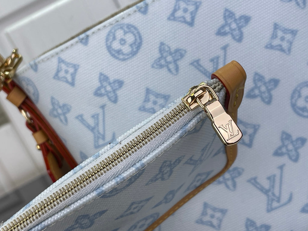 Louis Vuitton monogram pouch with gold zipper and tan leather trim, close-up detail