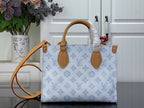 Louis Vuitton blue monogram tote bag with tan handles and leather key fob