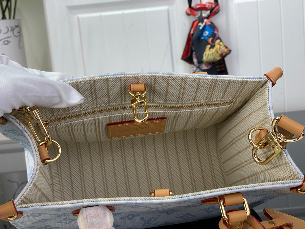 Louis Vuitton beige striped interior pouch with gold rings and tan leather trim