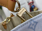 Louis Vuitton stamped clasp on tan leather strap attached to blue monogram bag