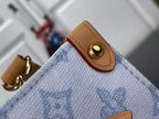 Louis Vuitton tan snap button on blue monogram tote corner with gold hardware