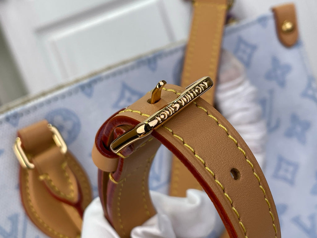 Louis Vuitton tan leather strap and gold buckle on blue monogram tote