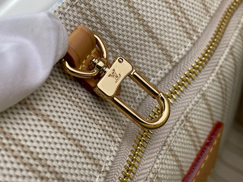 Louis Vuitton gold zipper pull and tan trim on beige interior pouch
