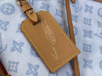 Leather luggage tag with gold-stamped initials on light blue monogram canvas