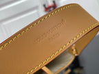 Louis Vuitton logo patch on tan leather bag panel with yellow stitching