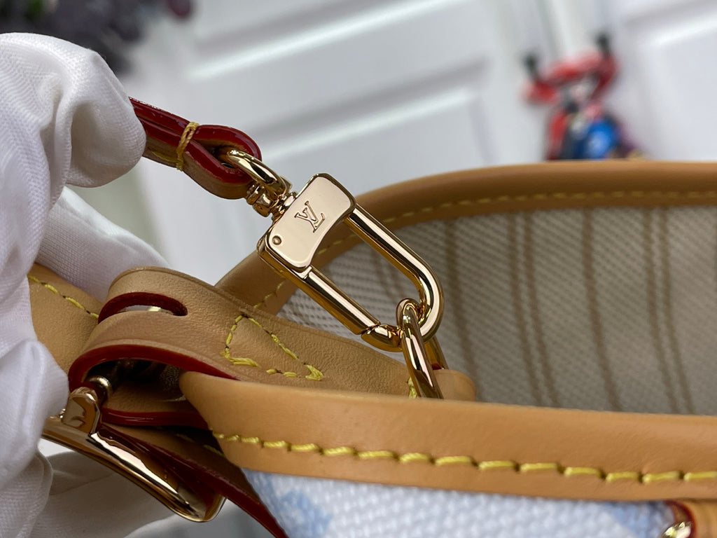 Louis Vuitton bag clasp on tan leather strap with gold hardware
