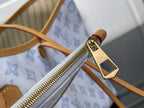 Louis Vuitton bag zip pull with gold hardware and tan leather trim
