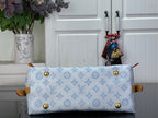 Hobo bag front panel with gold snap buttons and light blue monogram canvas