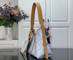 Hobo bag with tan shoulder strap and light blue monogram canvas, front view