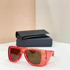 Sunglasses with dark lenses and red frames, with case behind