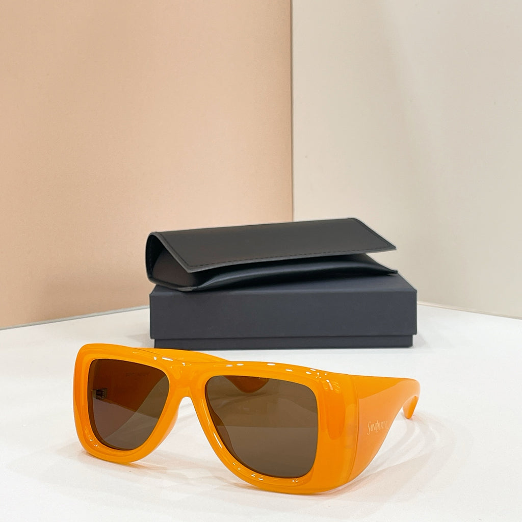 Sunglasses with dark lenses and orange frames, with case behind
