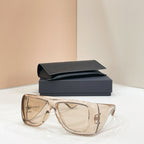 Sunglasses with clear lenses and translucent amber frames, with dark case behind