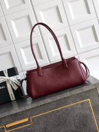 Chanel burgundy textured leather handbag with structured top and side strap loop