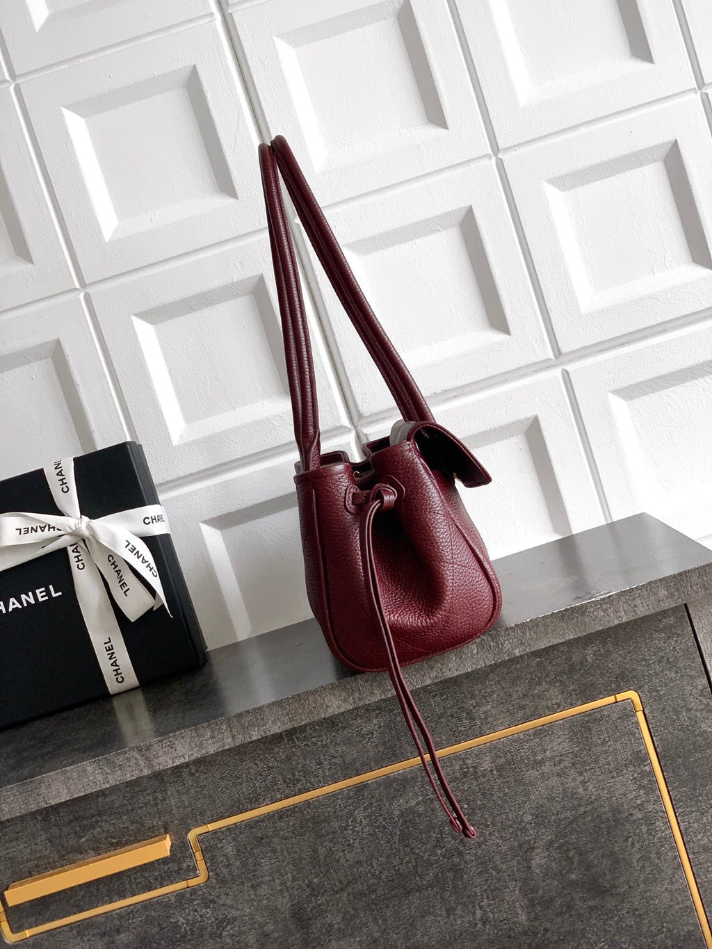 Chanel burgundy mini handbag with tall handles and crossbody strap, gold logo detail