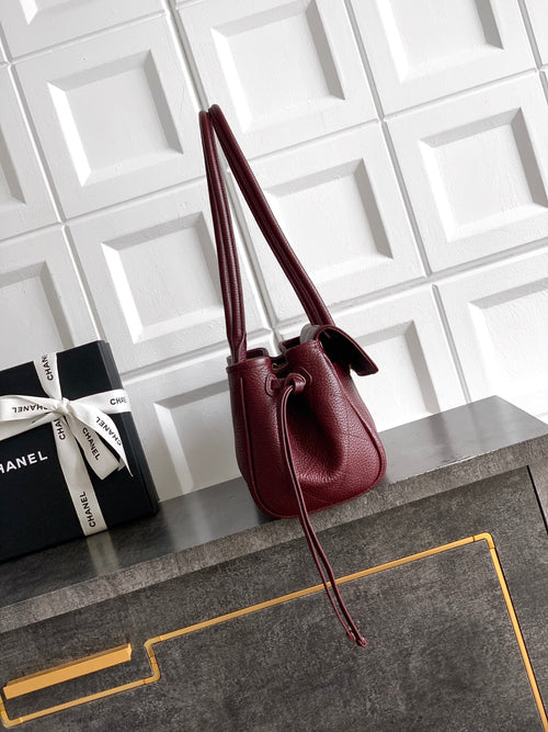 Chanel burgundy mini handbag with tall handles and crossbody strap, gold logo detail