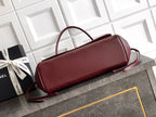 Chanel burgundy top-handle handbag with detachable crossbody strap and gold logo hardware