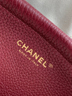 Chanel burgundy leather interior panel with gold Chanel logo and Made in Italy text