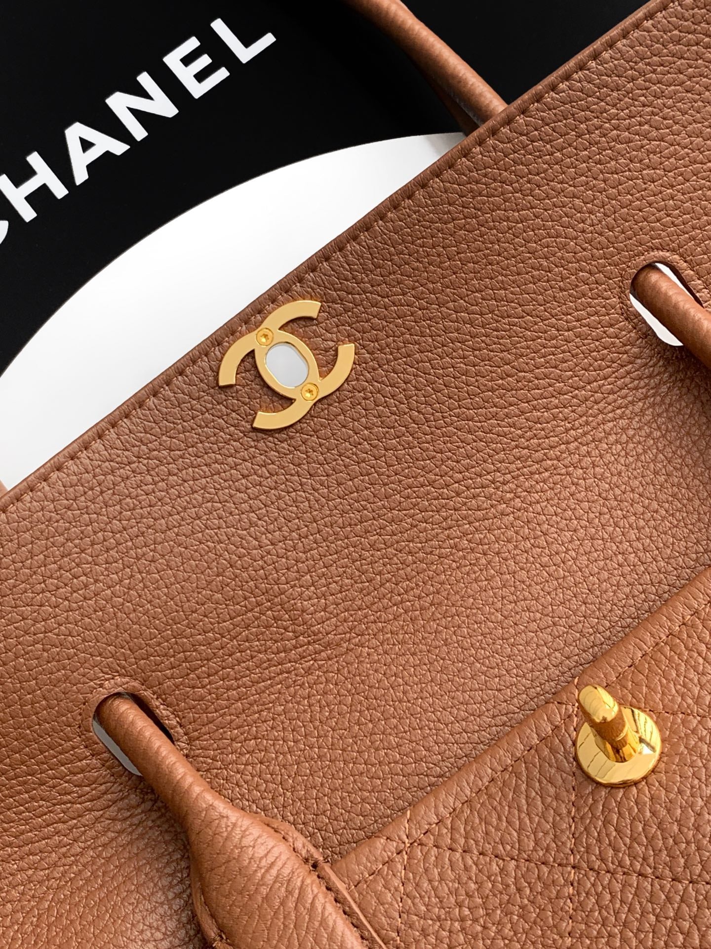 Chanel brown leather flap with gold CC logo and side loop details