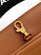 Chanel brown leather strap connector with gold-tone clasp and engraved emblem