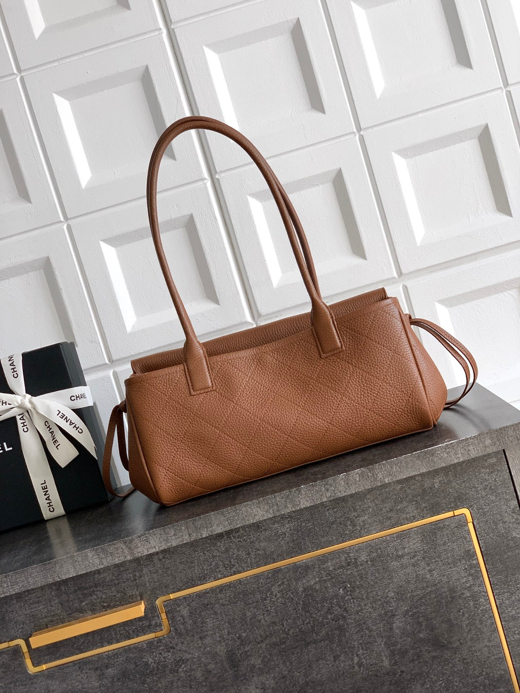 Chanel brown leather handbag with top handles and front flap, gold logo hardware