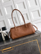 Chanel brown leather handbag with top handles and front flap, gold logo hardware