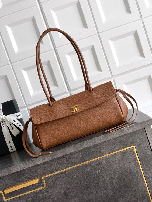 Chanel brown leather handbag with top handles, front flap, and gold logo