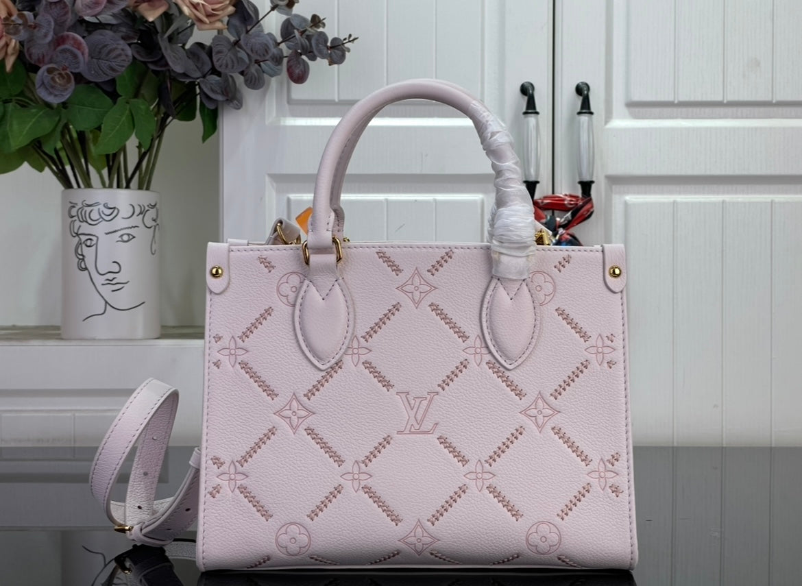 Light pink monogram tote bag with two top handles and matching crossbody strap